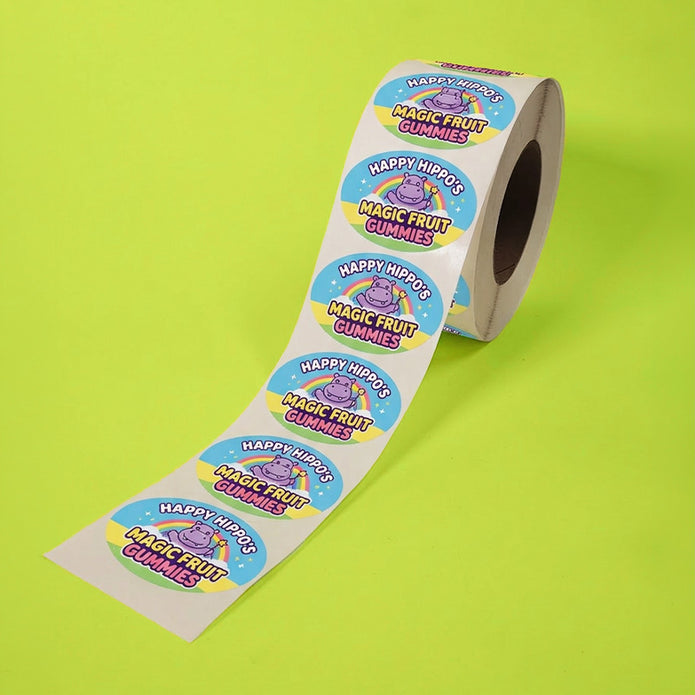 Roll of Happy Hippos Magic Fruit Gummies stickers on a green background
