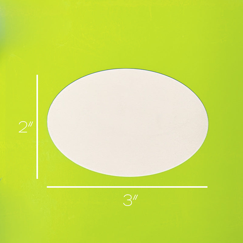 White oval object with measurements on a green background