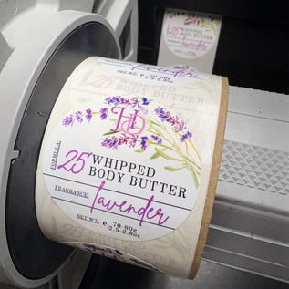 Roll of lavender whipped body butter labels on a printing machine.