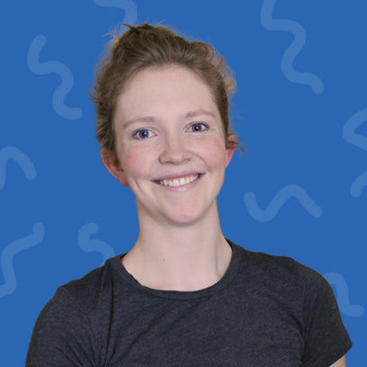 Person wearing a dark gray shirt against a blue background with wavy patterns