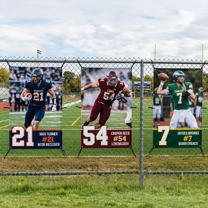 Football player posters on a chain-link fence with field background