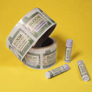 Bloom Botanicals lip balm packaging on a yellow background