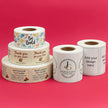 Rolls of customizable labels on a pink background