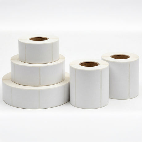 Five rolls of white label paper stacked on a white background