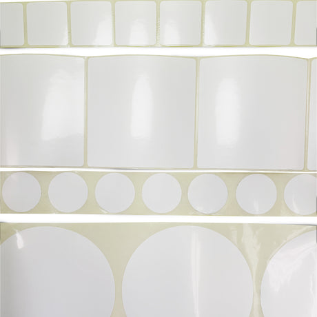 Set of white labels on a beige background