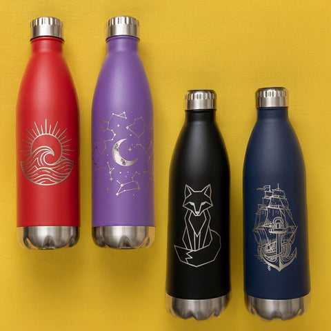 Four insulated bottles with engraved designs on a yellow background