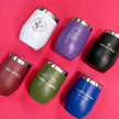 Set of personalized tumblers with various designs and text on a pink background