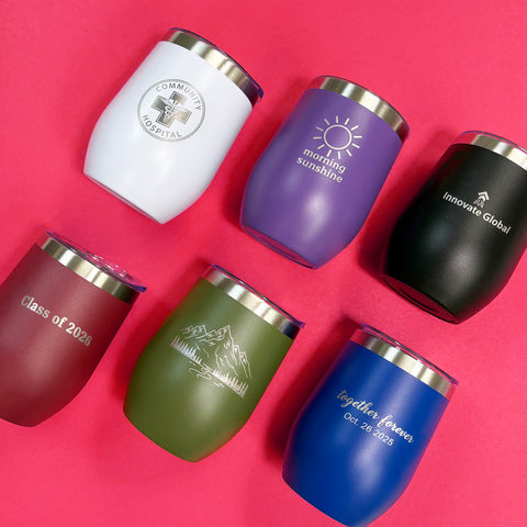 Set of personalized tumblers with various designs and text on a pink background