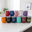 Collection of personalized insulated tumblers on a white surface with a neutral background.